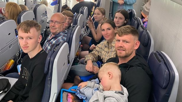 Michael Waite, front right, and bride-to-be Melissa Robinson, behind him, on the flight to Cyprus
